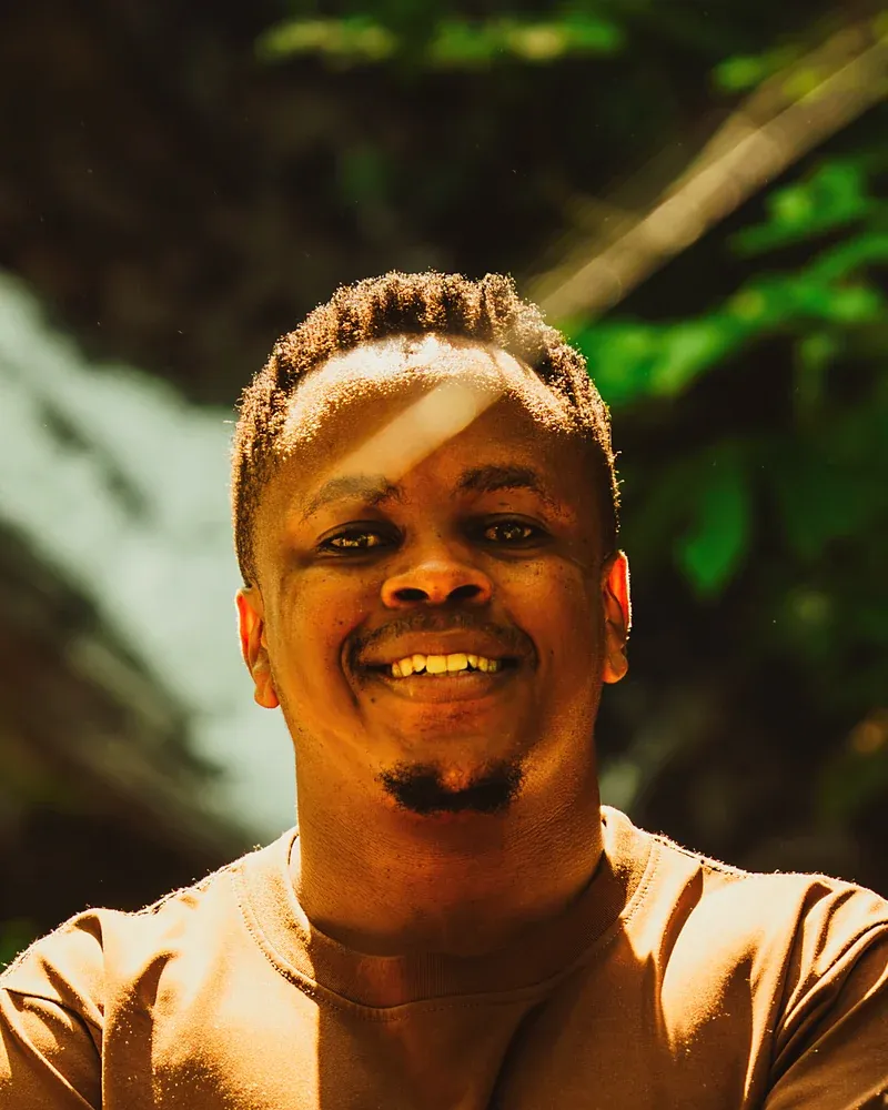 Headshot of Jordan Mtui smiling