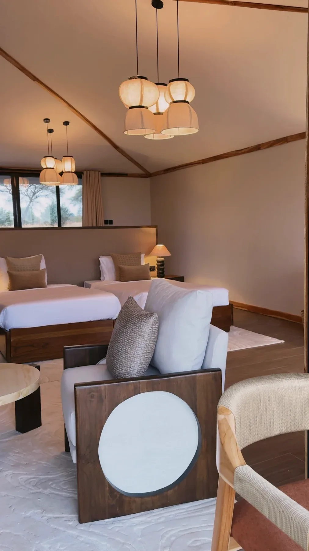 A warmly lit guest suite with timber furniture at Elephants Lair